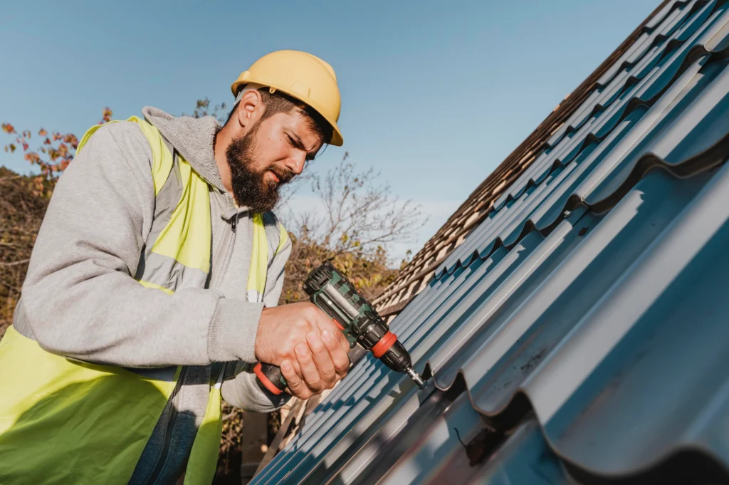 a person wearing helmet is doing roof repair using a drill machine